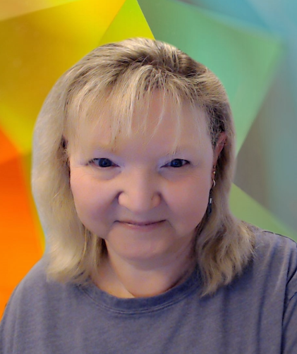 This is a headshot of Kelly Fonner. She is a white women with shoulder length blond hair. She has bangs and blue eyes. She is wearing a gray t-shirt and is in front of a brightly colored virtual background. 
